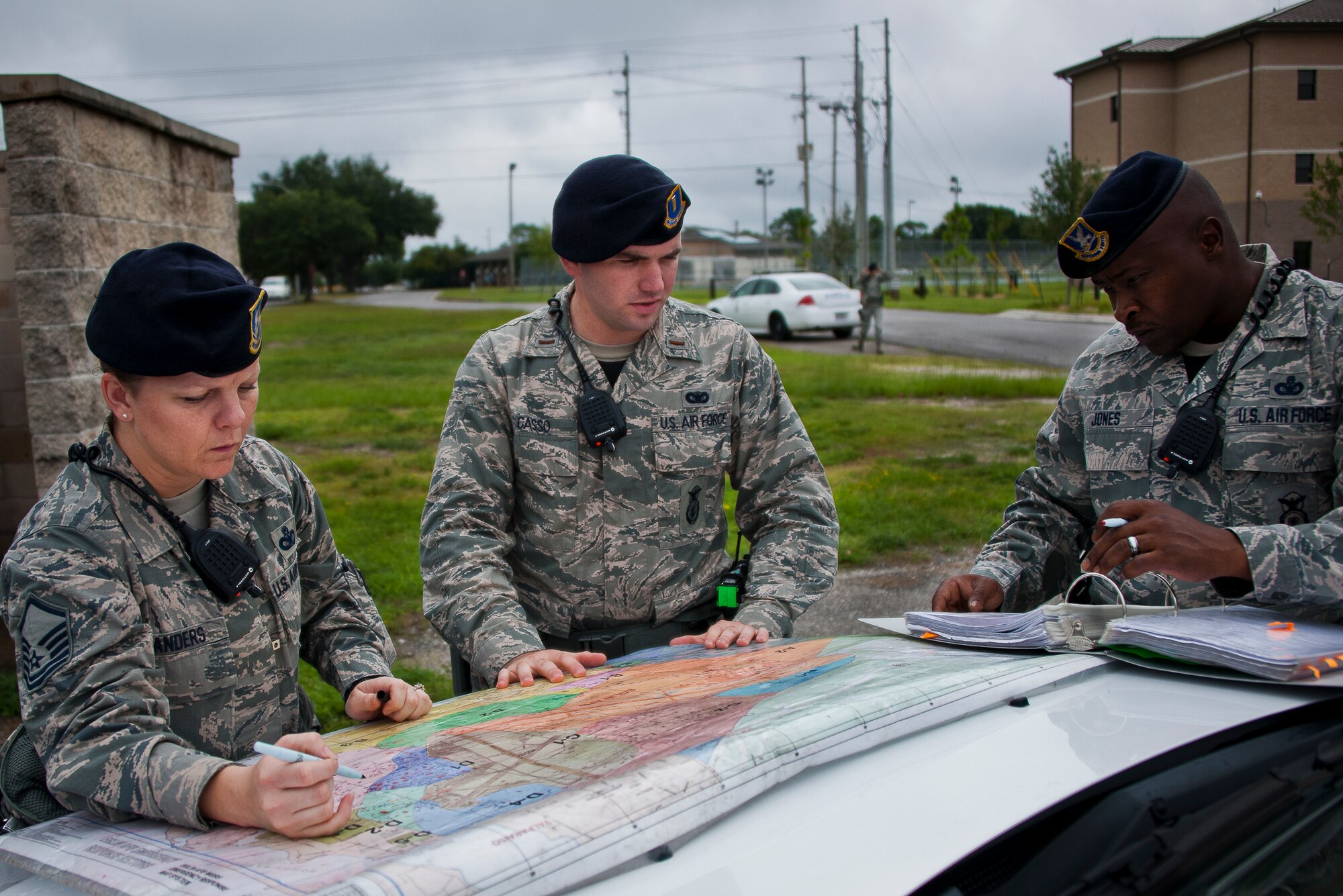 Airmen from the 96th Security Forces Squadron plot out a perimeter grid on a base map after a simulated explosion during a radiological and force protection condition exercise Aug. 16 at Eglin Air Force Base, Fla.  First responders from security forces, the fire department and medical group arrived to secure the scene and help the simulated victims.  (U.S. Air Force photo/Samuel King Jr.)