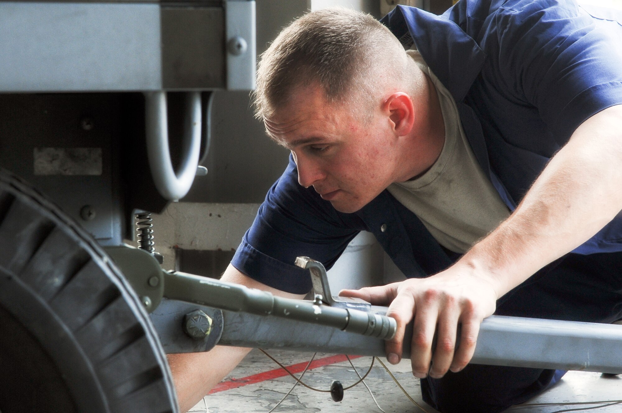 YOKOTA AIR BASE, Japan -- Tech. Sgt. Phillip Piddington, 374th Maintenance Squadron, checks levers on a light all Aug. 14, 2013, at Yokota Air Base, Japan. Piddington and other members of the Aerospace Ground Equipment flight complete inspections on flightline equipment on a scheduled basis. (U.S. Air Force photo by Senior Airman Desiree Economides)