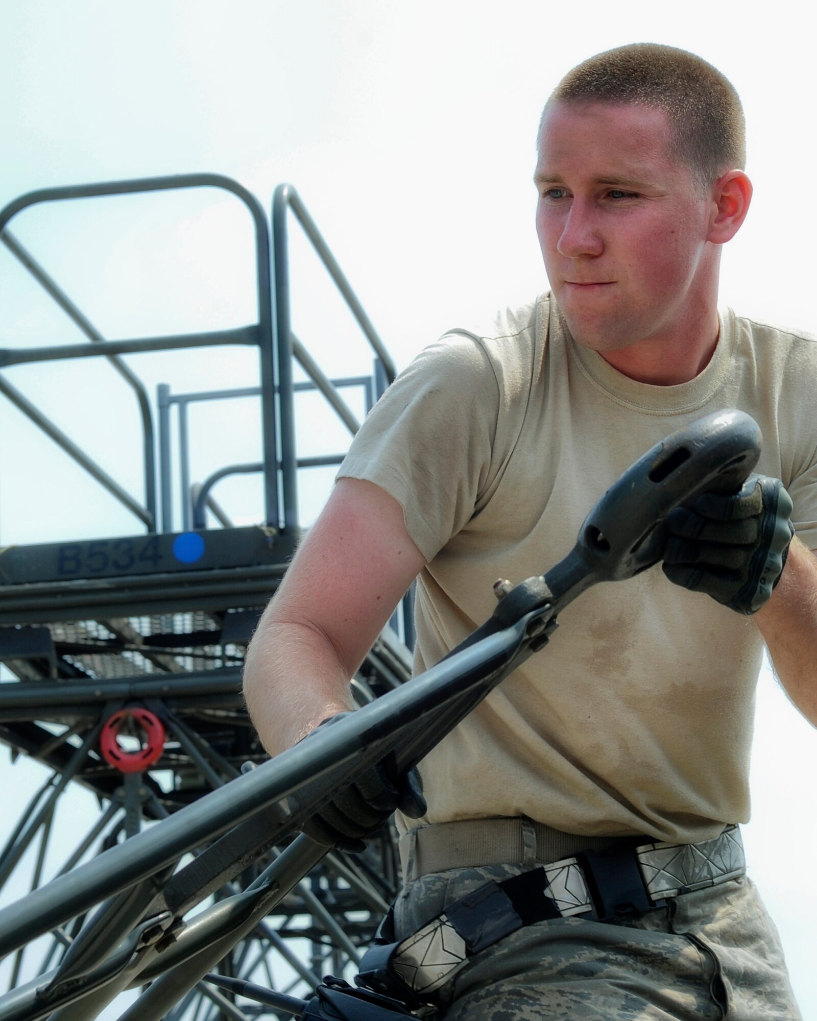 YOKOTA AIR BASE, Japan -- Airman 1st Class Michael Miller, 374th Maintenance Squadron Aerospace Ground Equipment apprentice, moves a stand into place Aug. 14, 2013, at Yokota Air Base, Japan. The AGE shop is responsible for maintaining equipment used on the flightline in addition to picking up and delivering it to the aircraft. (U.S. Air Force photo by Senior Airman Desiree Economides)