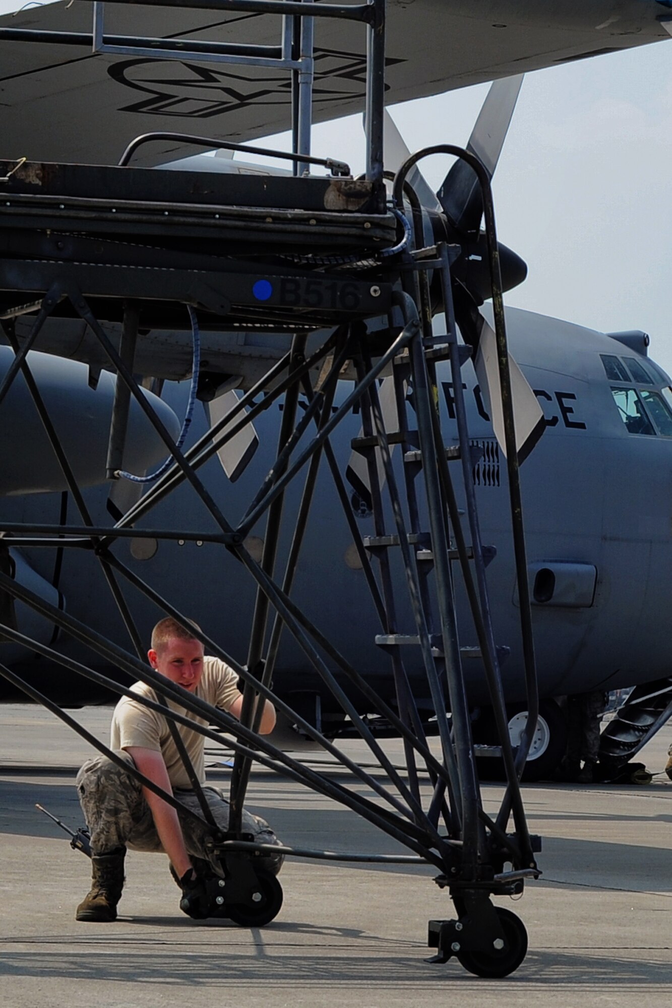 YOKOTA AIR BASE, Japan -- Airman 1st Class Michael Miller, 374th Maintenance Squadron, releases the breaks on a stand Aug. 14, 2013, at Yokota Air Base, Japan. As a member of the 374 MXS Aerospace Ground Equipment flight, Miller picks up and delivers equipment to aircraft. (U.S. Air Force photo by Senior Airman Desiree Economides)