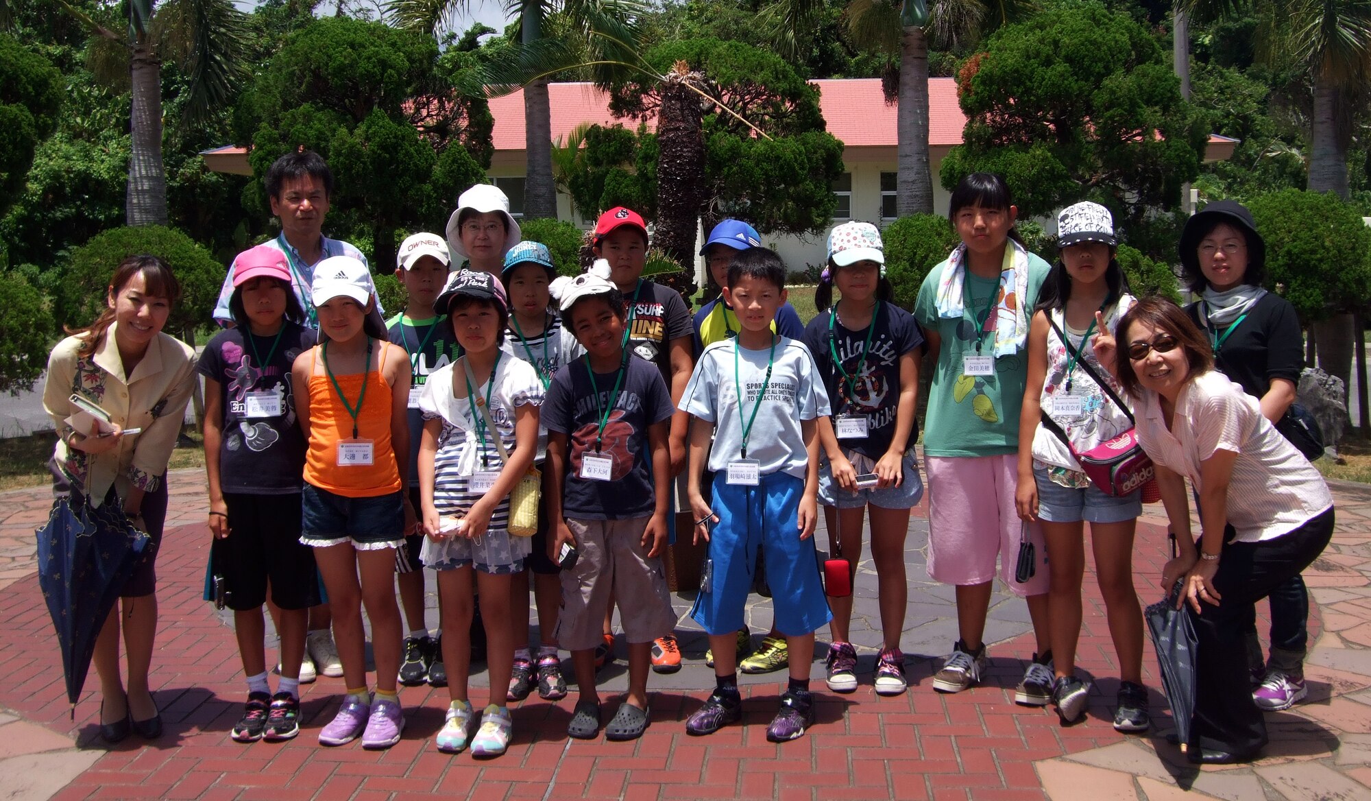 Japanese primary school children from Nagano Achi village pose for a group photo at the Peace Garden memorial on Kadena Air Base, Japan, Aug. 5, 2013. Approximately 12 children from Nagano Achi village visited Kadena as part of an annual Okinawa visit to the base. (Courtesy photo)