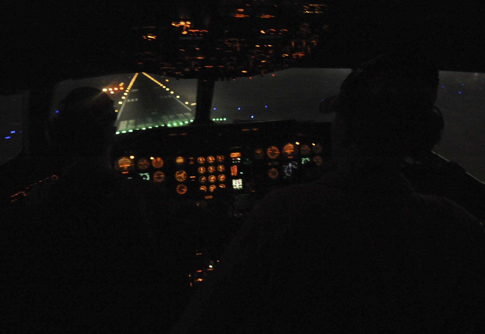 A KC-10 Extender crew of the 908th Expeditionary Air Refueling Squadron prepares to land at night at an undisclosed location in Southwest Asia Aug. 11, 2013. The refueling boom and hose and center-line drogue system of the KC-10 Extender are used to aerial refuel U.S. and allied aircraft. (U.S. Air Force photo by Staff Sgt. Jacob Morgan)