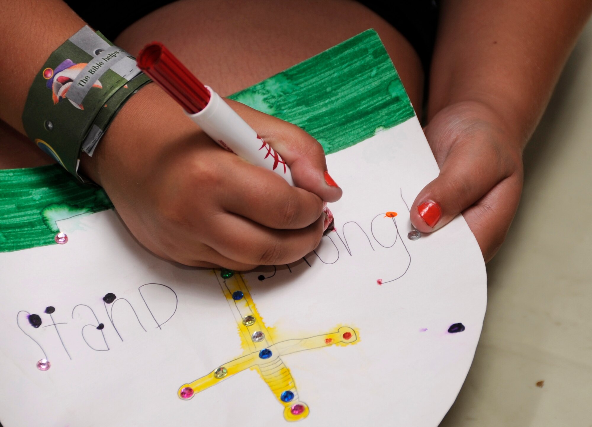 A child attending the 35th Fighter Wing Chapel Vacation Bible School crafts a personal crest at Misawa Air Base, Japan, Aug 16, 2013. About 200 children were in attendance at the chapel’s VBS doing many unique activities.  (U.S. Air Force photo by Airman 1st Class Kaleb Snay)