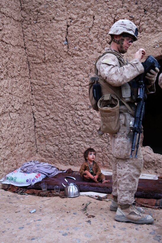 U.S. Marine Corps Cpl. Aaron Murphy, right, enrolls an Afghan villager into a secure electronic enrollment kit II system during a patrol in the Marjah district of Helmand province, Afghanistan, Aug. 15, 2013. Murphy, a team leader, is assigned to Fox Company, 2nd Battalion, 2nd Marine Regiment.