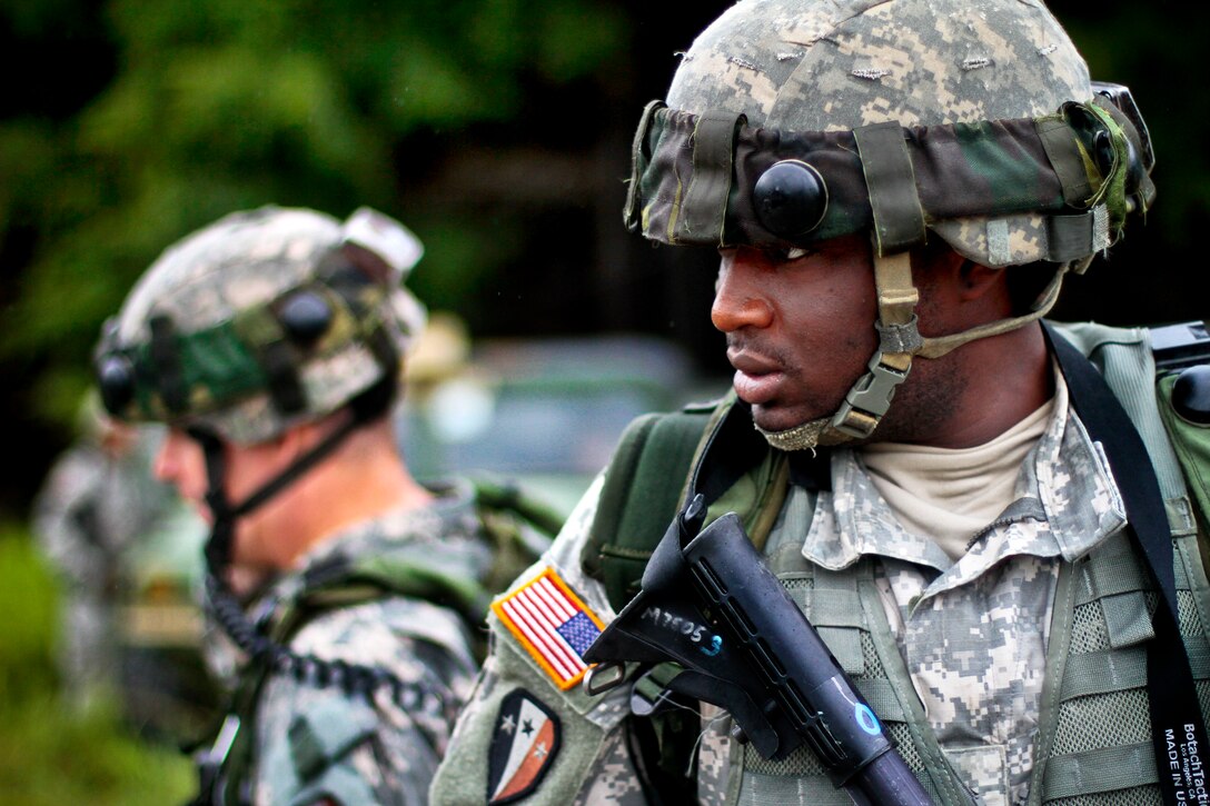 Army Sgt. Kevin Jones, right, provides security overwatch for Army Lt. Col. Thomas Hallowell during a field training exercise on Fort Pickett, Va., Aug. 18, 2013. Jones is assigned to the New Jersey Army National Guard's 1st Battalion, 114th Infantry Regiment, 50th Infantry Brigade Combat Team.