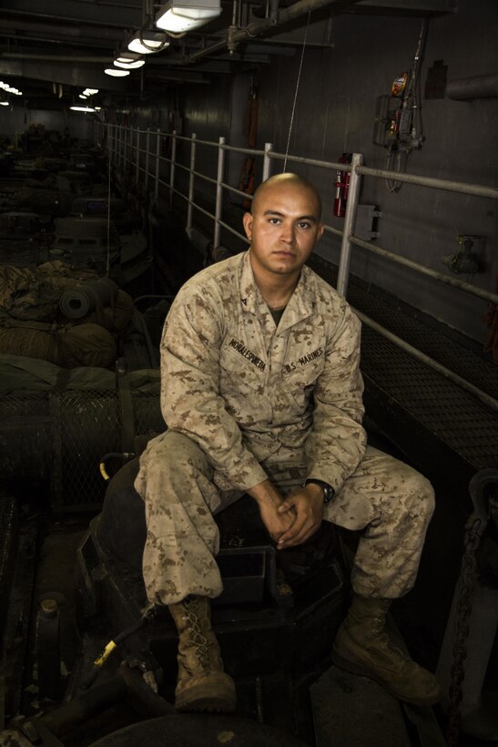 U.S. Marine Corps Lance Cpl. Alvara Morales, is an amphibious assault vehicle crewman from Miami, assigned to Company K, Battalion Landing Team 3/2, 26th Marine Expeditionary Unit (MEU), aboard the USS Carter Hall (LSD 50), at sea, Aug. 13, 2013. The 26th MEU is a Marine Air-Ground Task Force forward-deployed to the U.S. 5th Fleet area of responsibility aboard the Kearsarge Amphibious Ready Group serving as a sea-based, expeditionary crisis response force capable of conducting amphibious operations across the full range of military operations. (U.S. Marine Corps photo by Cpl. Michael S. Lockett/Released)
