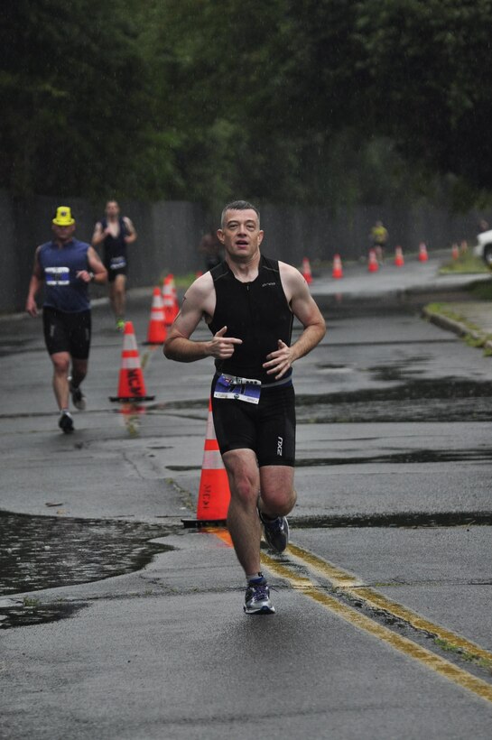 Triathlete, Jeff Odom, runs the final portion to the Quantico Triathlon on Marine Corps Base Quantico, Aug. 18, 2013. Triathletes  participated in the first Quantico Triathlon  which included a 400 meter pool swim, followed by a nine-mile bike race and finished with a five kilometer run.  