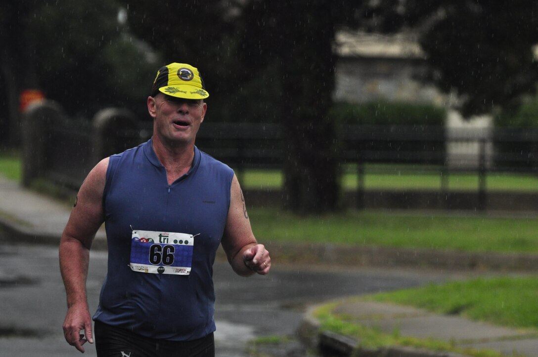 Col. David W. Maxwell, Marine Corps Base Quantico base commander, runs the final portion to the Quantico Triathlon on Marine Corps Base Quantico, Aug. 18, 2013. Triathletes  competed in the first Quantico Triathlon  which included a 400 meter pool swim, followed by a nine-mile bike race and finished with a five kilometer run.  