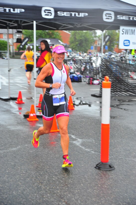 Triathlete, Jane Kelly-Langford, begins the final portion of the triathlon aboard Marine Corps Base Quantico on Aug, 18, 2013. This lady was the first female to complete the event which included a 400-meter swim, nine-mile bicycle race and five-kilometer run.
