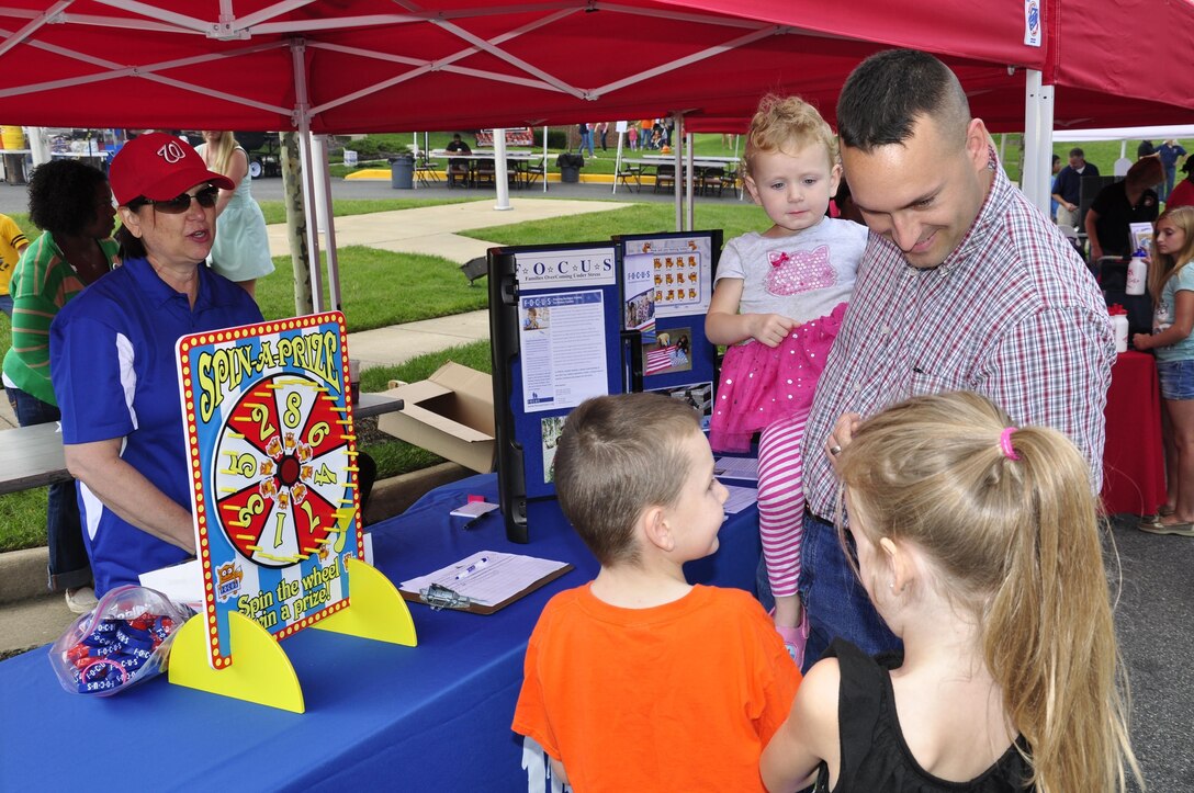 Service members brought their families to the 2013 National Day Out: Back to School Event on Aug. 18, 2013, outside of the Lincoln Military Housing Family Housing Center aboard Marine Corps Base Quantico. The Provost Marshal's Office, Marine Corps Community Services and Lincoln Military Housing co-sponsored the event after National Night Out was cancelled on the base due to budget cuts.