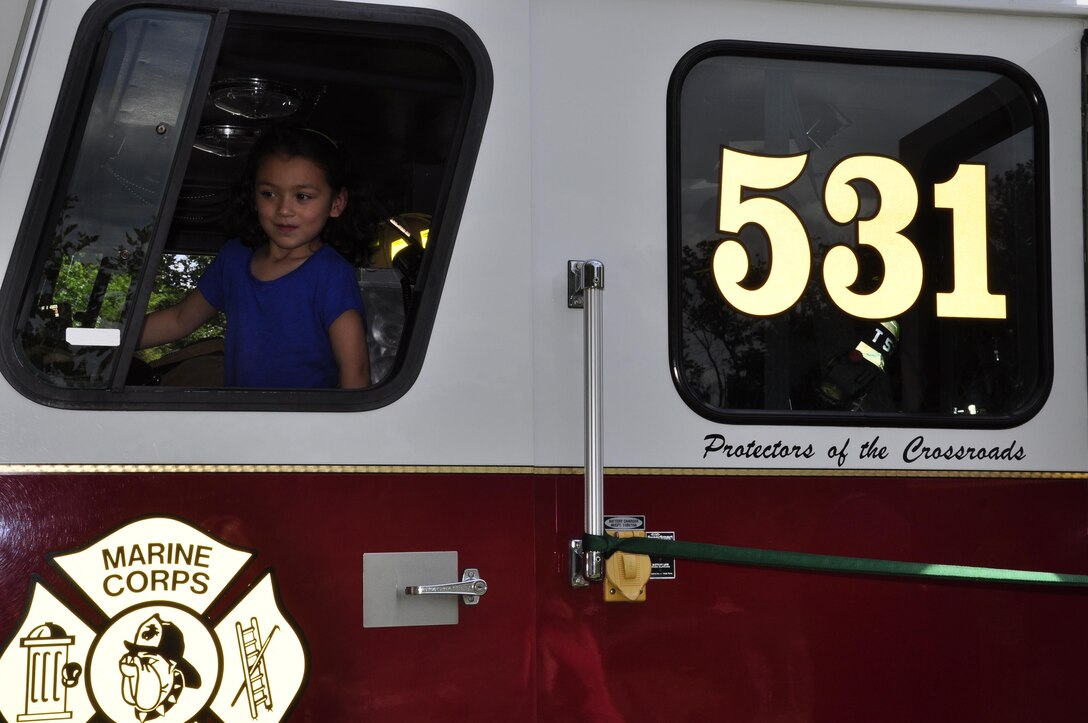 Hannah, 7, sits in the driver's seat of a Marine Corps Base Quantico fire truck during the 2013 National Day Out: Back to School Event on Aug. 18, 2013, outside of the Lincoln Military Housing Family Housing Center aboard Marine Corps Base Quantico. The Provost Marshal's Office, Marine Corps Community Services and Lincoln Military Housing co-sponsored the event after National Night Out was cancelled on the base due to budget cuts.