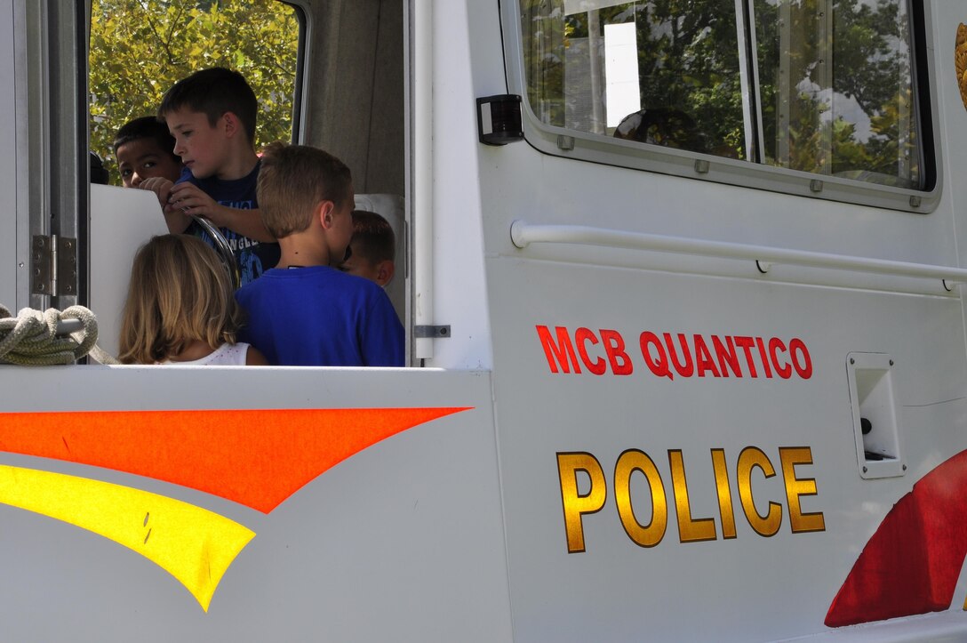 Children check out the Marine Corps Base Quantico police boat during the 2013 National Day Out: Back to School Event on Aug. 18, 2013, outside of the Lincoln Military Housing Family Housing Center aboard Marine Corps Base Quantico. The Provost Marshal's Office, Marine Corps Community Services and Lincoln Military Housing co-sponsored the event after National Night Out was cancelled on the base due to budget cuts.