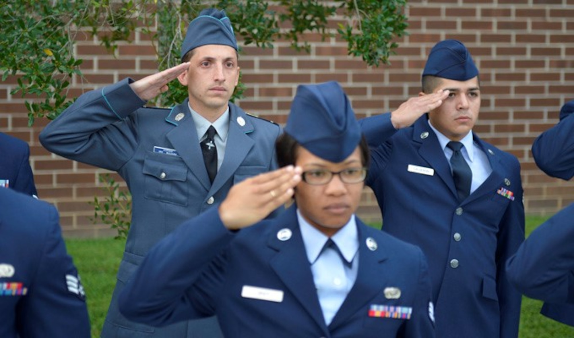 Corporal Stoyko V. Stoykov, an Airman with the Bulgarian air force, salutes with U.S. Air Force members and classmates August 15, 2013, during a reveille ceremony at McGhee Tyson Air National Guard Base, Tenn. Stoykov graduated from Airman Leadership School along with Bulgarian Sergeant Yordanka S. Petrova-Angelova, who graduated from the NCO Academy, as a result of international relations built through the Tennessee National Guard State Partnership Program.