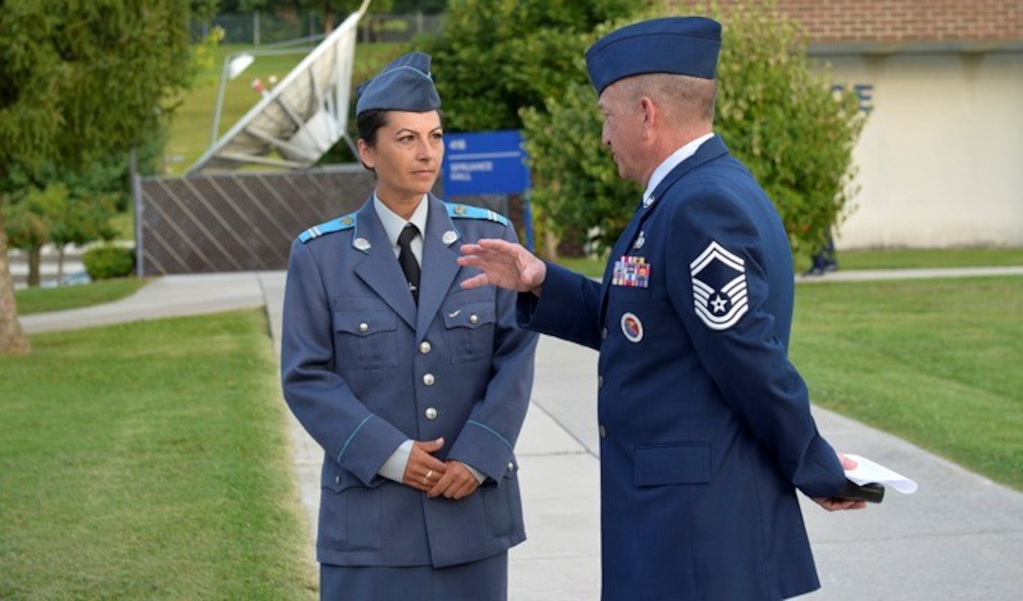 Sgt. Yordanka S. Petrova-Angelova with the Bulgarian air force talks with Senior Master Sgt. Andrew Traugot here August 15, 2013, at McGhee Tyson Air National Guard Base. Petrova-Angelova graduated from the U.S. Air Force NCO Academy along with Bulgarian Cpl. Stoyko V. Stoykov, who attended Airman Leadership School at around the same time. The bulgarian Airmen completed the leadership education this summer as part of relations built through the Tennessee National Guard State Partnership Program. Traugot is the director of education, Satellite EPME at the I.G. Brown Training and Education Center.