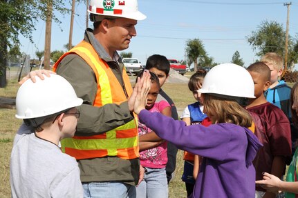 A group of Wilson Elementary students get a lesson in engineering as part of STARBASE OK, an initiative funded by the Oklahoma Air National Guard at Fort Still, Okla., Oct. 27, 2010. The students donned hard hats to volunteer as Brad Carter, civil engineer, used simple exercises to explain engineering terms like compression, tension and deflection.