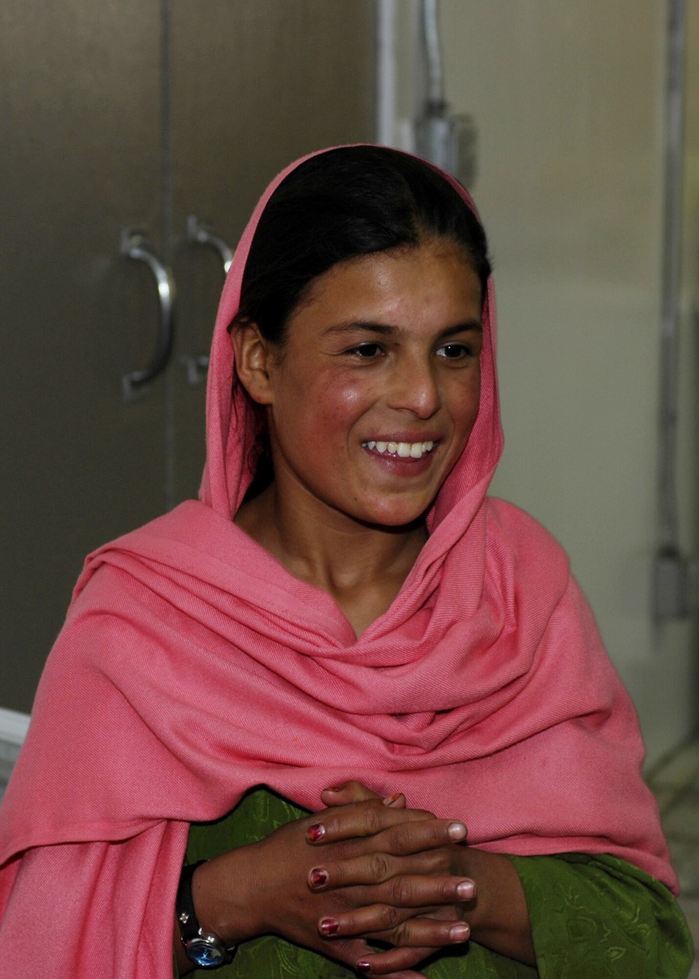 Lamia, a 10-year-old Afghan girl from Shakal Village, shows her appreciation to the donated items sent from Jan Bradley, wife of Lt. Gen. John Bradley, Air Force Reserve Command commander. Mrs. Bradley spearheaded a donation drive that provided several boxes of housewares, clothing, shoes, toys and toiletries. (U.S. Air Force photo/Capt. Toni Tones)