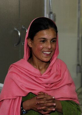 Lamia, a 10-year-old Afghan girl from Shakal Village, shows her appreciation to the donated items sent from Jan Bradley, wife of Lt. Gen. John Bradley. Jan spearheaded a donation drive that provided several boxes of housewares, clothing, shoes, toys and toiletries. Bradley is the Air Force Reserve Command commander. (U.S. Air Force photo/Capt. Toni Tones)