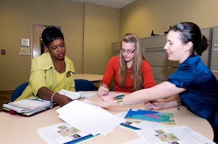 Fort Jackson's Survivor Outreach Services Coordinator, Leslie Smith, left, goes over paperwork with South Carolina Army National Guard's Beth Carney, center, and the Army Reserve's Megan McCullough, right, during a recent meeting at the 81st Regional Support Command headquarters building on Fort Jackson, S.C.