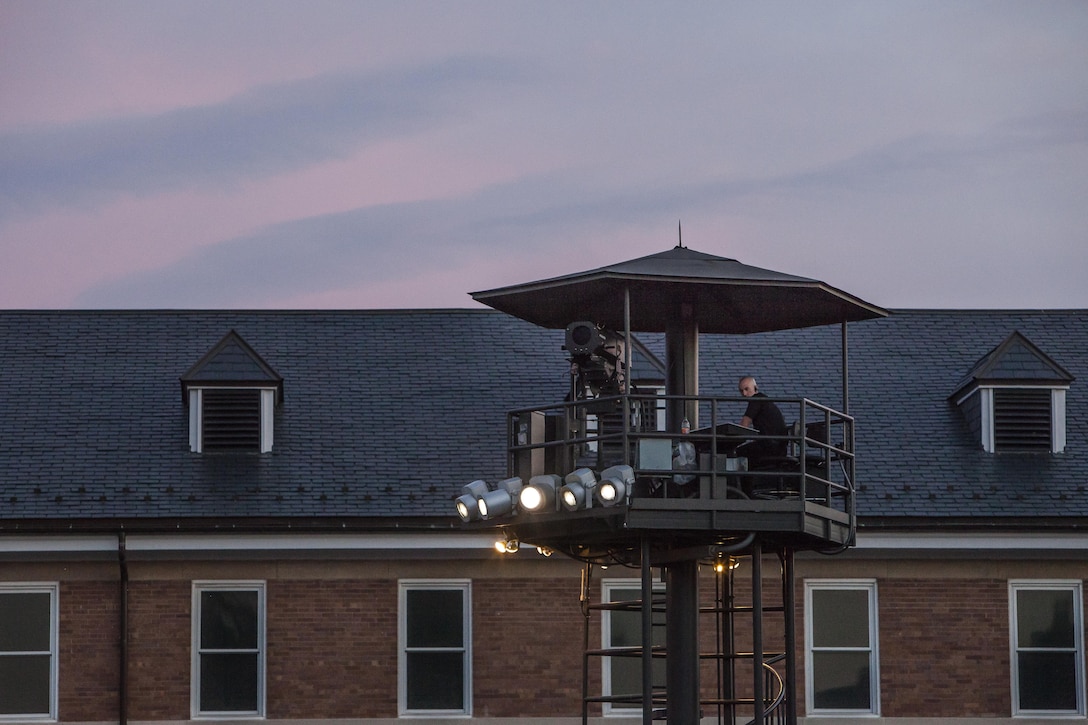 Sgt. Dexter Thompson, a lighting technician with Marine Barracks Washington, D.C., takes his post during a Friday Evening Parade at the Barracks Aug. 16. 