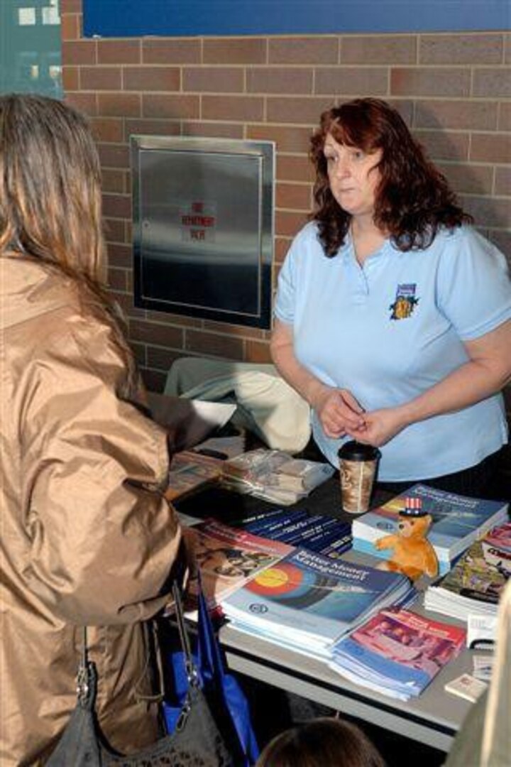 Connie S. Douthat, Family Programs coordinator for the 122nd Fighter Wing of the Indiana Air National Guard, discusses support programs available to military personnel at a welcome home celebration held at Lucas Oil Stadium in Indianapolis, Ind., Jan. 31, 2010.