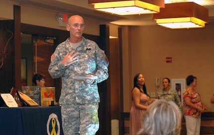 Army National Guard Command Sgt. Maj. Richard Burch gives an overview of "The Senior Enlisted and Spouses Reintegration Professional Development Workshop" to fellow Soldiers and Army Guard spouses at the Westin La Paloma resort in Tucson, Ariz., July 13. The week-long conference highlighted several family support and professional development programs available to Guardsmen and families.