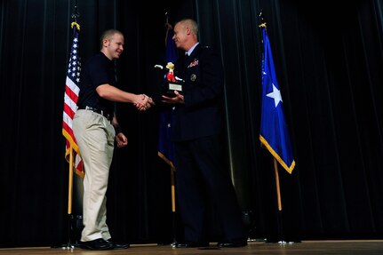 Dakota Johnson, left, shakes hands with Air Force Lt. Gen. Richard Newton, deputy chief of staff for manpower and personnel at U.S. Air Force Headquarters, while being recognized as the Air National Guard's Youth of the Year as part of the 2010 Air Force Youth of the Year awards program during a ceremony at the Pentagon, Thursday, June 24, 2010.