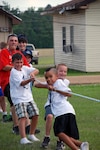 Youth at Kid's Annual Training play tug-of-war at Camp Beauregard in Pineville, La., June 16, 2010. More than 170 dependants or siblings of Louisiana National Guardsmen participated in the four-day camp intended to build leadership skills, give military children a chance to bond with other military kids and have fun.