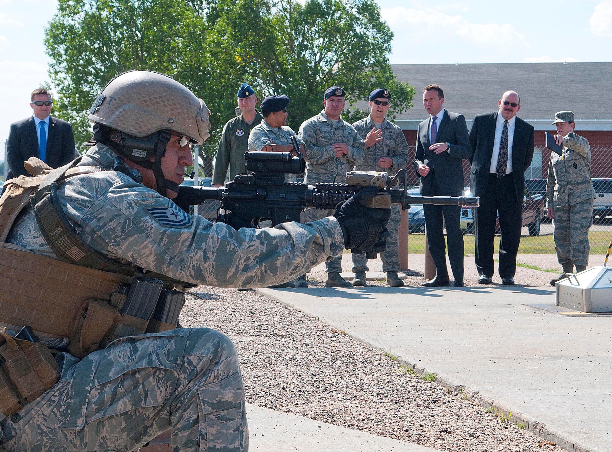 Acting Secretary of the Air Force Eric Fanning (third from right) watches Tech. Sgt. Bobby DeLeon demonstrate the 90th Security Group Tactical Response Force team’s capability during a visit to the 90th Missile Wing’s training launch facility August 15, 2013, at F.E. Warren Air Force Base. Fanning visited the base as part of a familiarization tour around Air Force installations.  