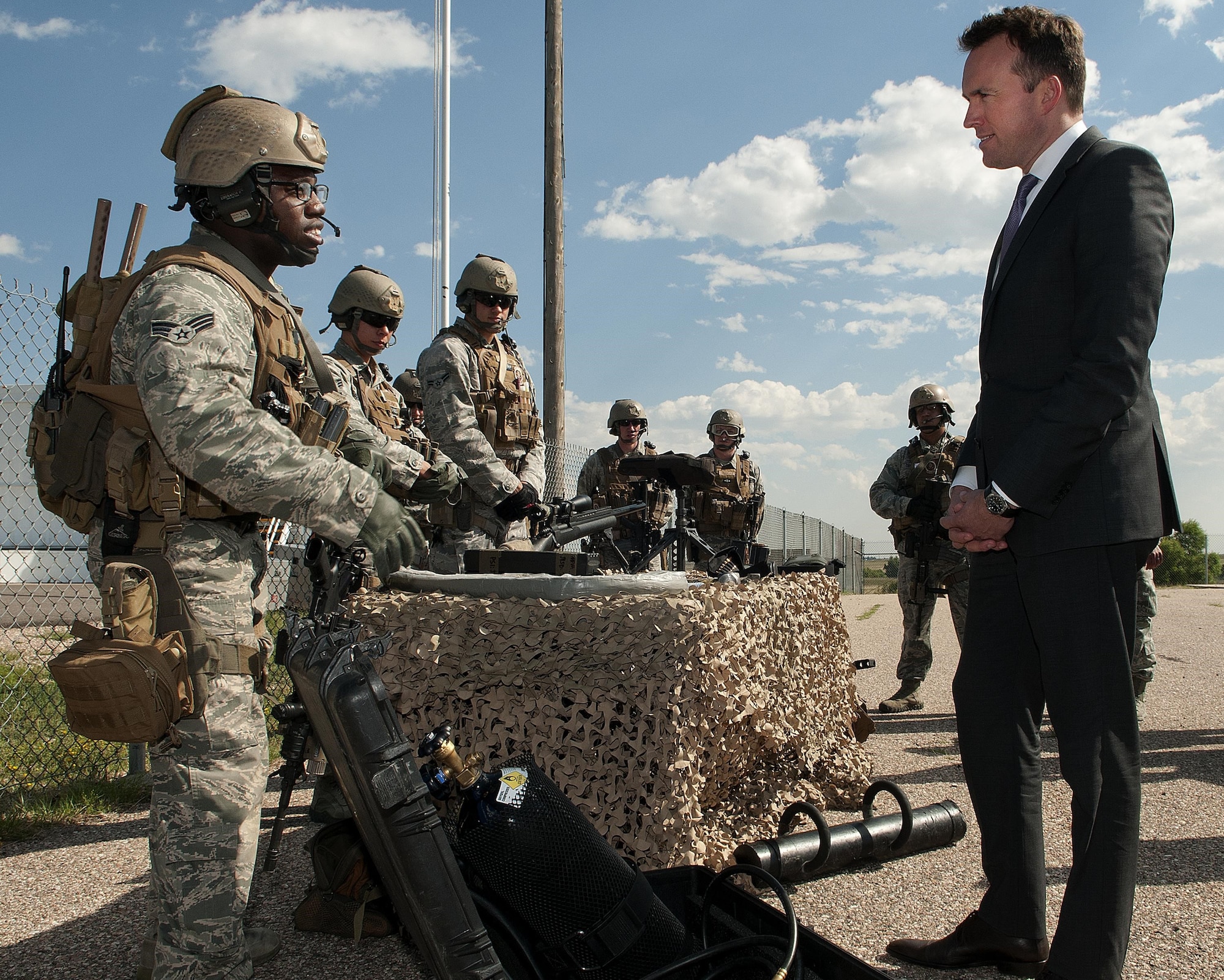 Acting Secretary of the Air Force Eric Fanning (right), listens to a brief by Senior Airman Anthony Black during a visit Aug. 15, 2013, to F.E. Warren Air Force Base, Wyo. Black talked to Fanning about explosive and mechanical means of forcing entry into spaces while other members of his team briefed the secretary on weapons and tactics. The TRF’s mission is to protect or if need be, recapture the 90th Missile Wings nuclear assets. Black is a 90th Security Group Tactical Response Force breacher.
