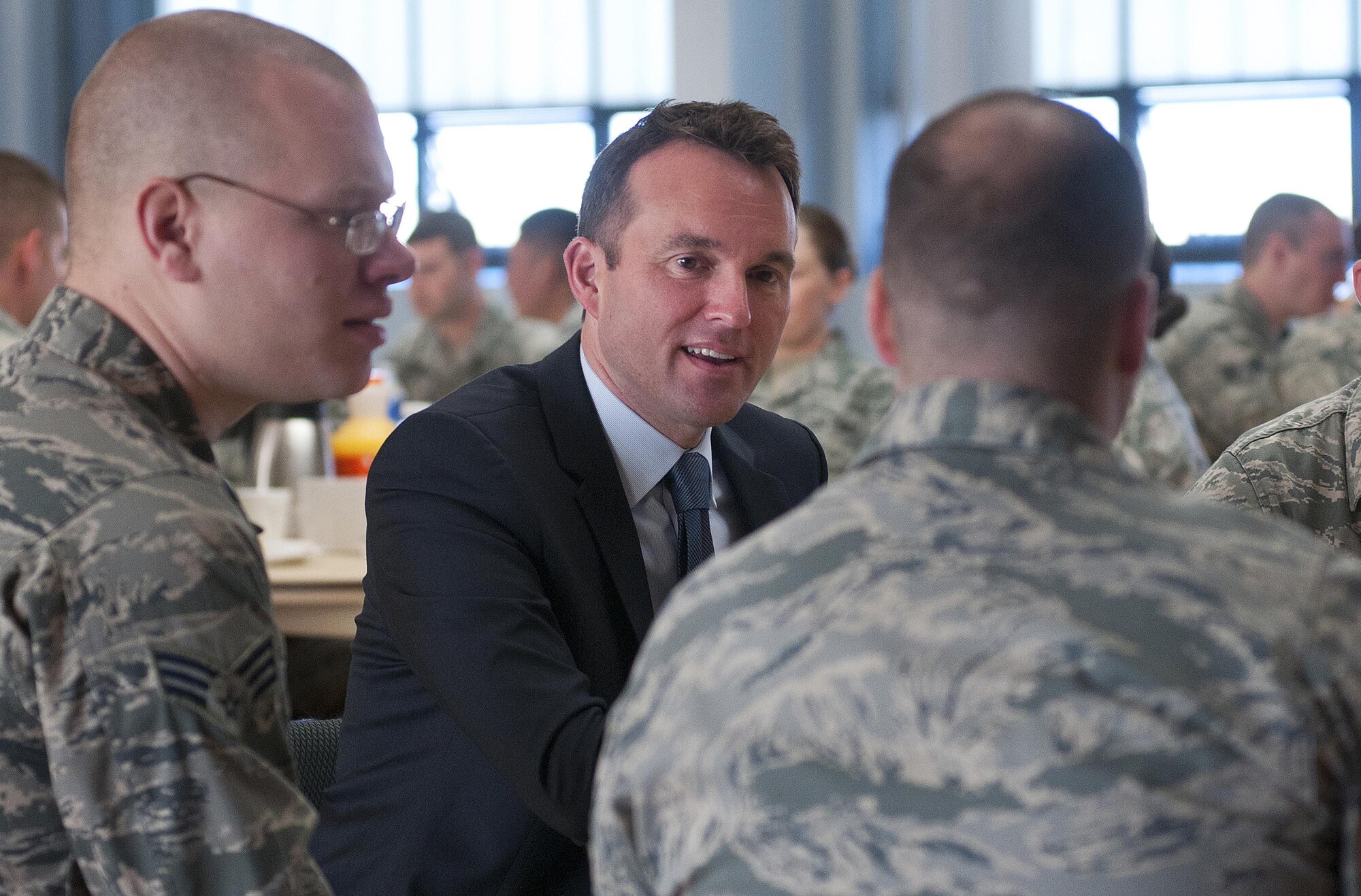 Acting Secretary of the Air Force Eric Fanning, visits with Senior Airmen David Chupak and Christopher Baskerville during breakfast with Airman Leadership School students August 16, 2013, at F.E. Warren Air Force Base, Wyo. Fanning visited the base in an effort to familarize himself with the variety of missions conducted throughout the Air Force after assuming his duties as secretary.