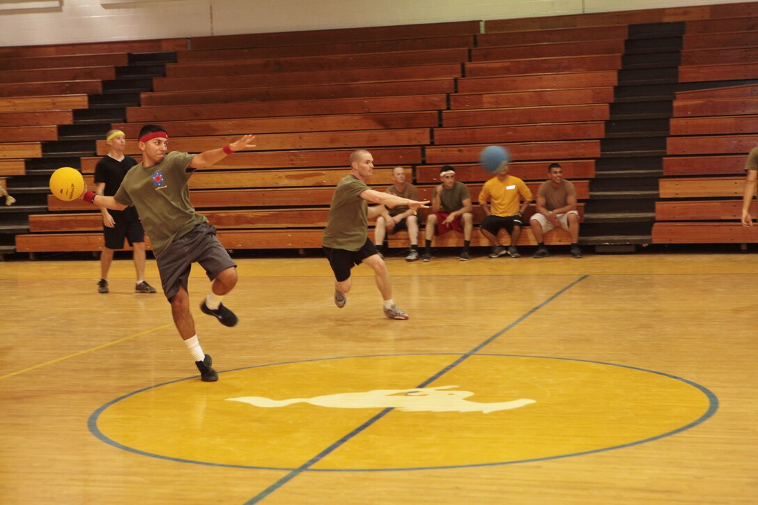 Lance Cpl. Jovan Caballeros, a motor transportation operator with 6th Engineer Support Battalion, winds up his throw as Navy Petty Officer 3rd Class Dale Dixon, a hospital corpsman with Detachment 2, Group Aid Support, 4th Marine Logistics Group, releases his shot in a coordinated attack to “peg out” an adversary during the Innovative Readiness Training Joint Task-Force Summit West Virginia final dodge ball game, at Mount Hope, W. Va., Aug. 7, 2013. IRT is a Marine-led training event with support from the Navy Reserve Forces Command, Army Reserve and Army National Guard. It provides real-world training opportunities for service members and units to prepare them for their wartime missions while supporting the needs of America’s underserved communities. (U.S. Marine Corps photo by Cpl. Fenton Reese)
