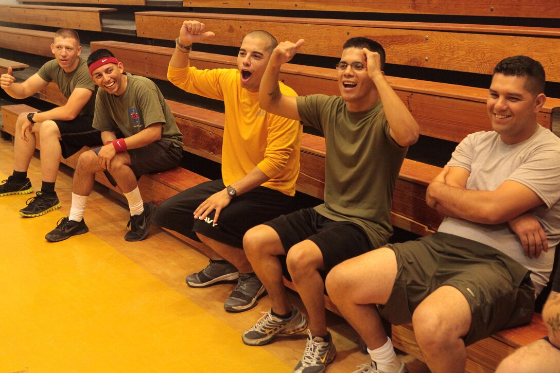 Cpl. Julio Vazquez, a motor transport operator with 6th Engineer Support Battalion, and Petty Officer 3rd Class Trent Brown, construction electrician with Naval Mobile Construction Battalion 23, taunt a fellow service member that they believe was tagged out during Innovative Readiness Training, Joint Task-Force Summit West Virginia’s final dodge ball game, Aug. 7, 2013. IRT is a Marine-led training event with support from the Navy Reserve Forces Command, Army Reserve and Army National Guard. It provides real world training opportunities for service members and units to prepare them for their wartime missions while supporting the needs of America’s underserved communities. (U.S. Marine Corps photo by Cpl. Fenton Reese)