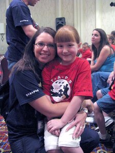 Staff Sgt. Mandi Hagen of the North Dakota Air National Guard's 119th Wing hugs her mentee during the Tragedy Assistance Program for Survivors (TAPS) at a Good Grief Camp in Washington, D.C., May 29, 2010. This is Hagen’s fourth year volunteering her personal time and money to take part in the camp that focuses on helping children of military families who have lost loved ones. Hagen is one of five Airmen from the North Dakota Air National Guard who participated in the Good Grief Camp this year.