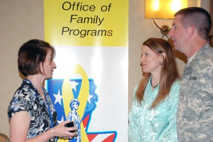 Danielle P. Trosclair shares family support information with Louisiana Army Guardsman 2nd Lt. Anthony B. Ray and his wife, Tonya. Trosclair, a support specialist with the Air National Guard Yellow Ribbon Reintegration Program, was one of many agency providers participating in the Louisiana National Guard's Office of Family Programs conference held in New Orleans May 21-23, 2010.