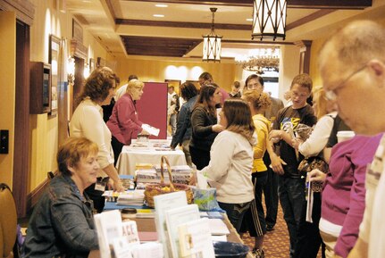 Participants of the Yellow Ribbon Reintegration event register and peruse the exhibition tables at Hershey Lodge in Hershey, Pa., April 16, 2010. The two-day event provided deployed Airmen resources to help ease their transition home after a deployment.