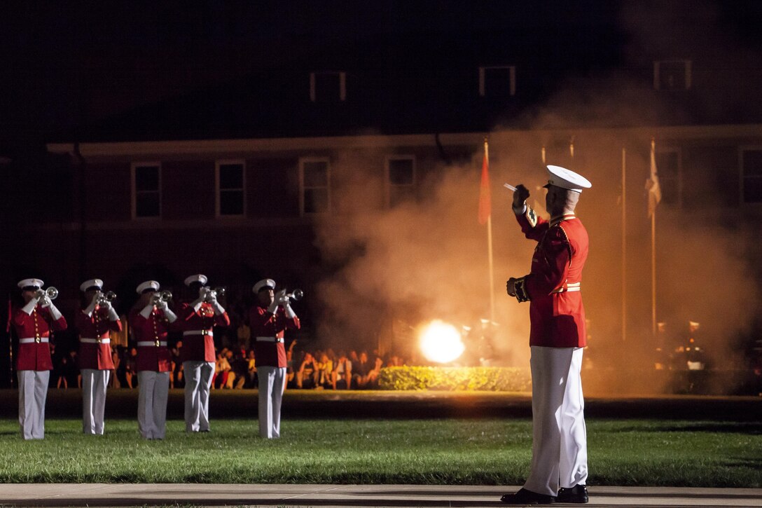 Ceremonial cannons are fired as signaled by Maj. Brian Dix, U.S. Marine Drum & Bugle Corps director, during a Friday Evening Parade at Marine Barracks Washington, D.C., Aug. 16. 