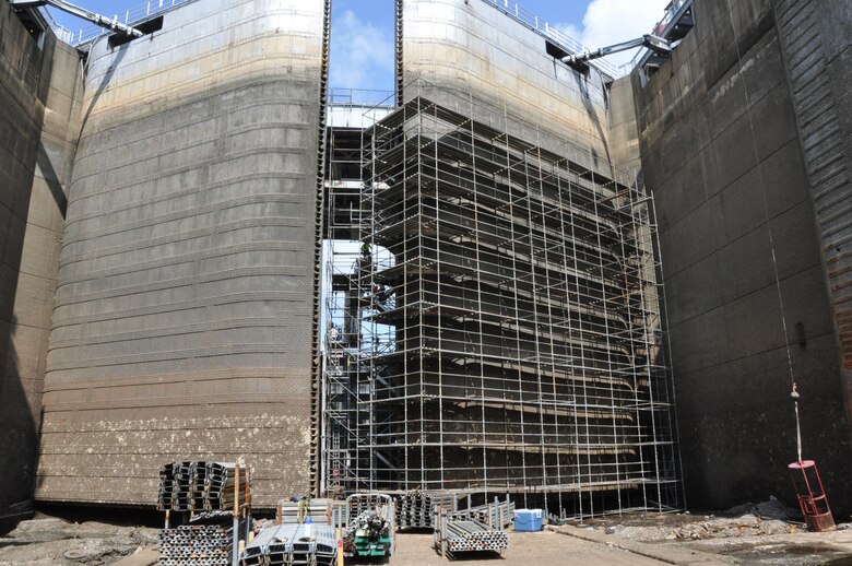 This view of Kentucky Lock’s lower miter gates should give the reader an idea of the size of the 91-feet tall gates that close off the lower end of the dewatered 110-by-600-foot navigational lock. The wraparound scaffold is being assembled to permit TVA-contracted GUBMK Constructors to sandblast, make any needed internal structural repairs, and paint the 91-foot tall miter gates. The U.S. Army Corps of Engineers Nashville District employees dewatered the 69-year-old, 110-by-600-foot lock and will inspect the culvert valves and all other areas of the lock that are normally underwater for any needed repairs. Corps employees will also replace the tow haulage system, used to move unpowered sections of barge tows through the lock. Kentucky lock is scheduled to resume normal operation at noon, Sept. 24, 2013. 