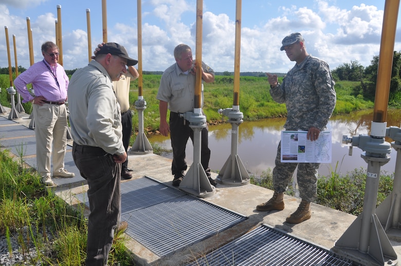 Chuck Hayes, supervisory wildlife biologist for the Fish and Wildlife Service (left) and Russ Webb, refuge manager for the Savannah National Wildlife Refuge, show Col. Thomas J. Tickner, commander of the U.S. Army Corps of Engineers Savannah District, the freshwater control structures built by the Corps in 2010 at the wildlife refuge. 