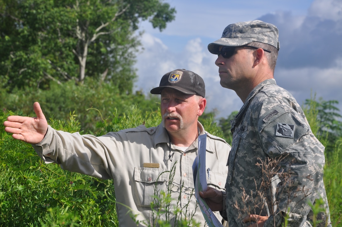 Chuck Hayes, supervisory wildlife biologist with the U.S. Fish and Wildlife Service, speaks with Col. Thomas J. Tickner, commander of the U.S. Army Corps of Engineers, during a visit to the Savannah National Wildlife Refuge, Aug. 19, 2013. Established in 1927 and operated by the U.S. Fish and Wildlife Service, the refuge provides more than 29,000 acres of freshwater marshes, tidal rivers and bottomland hardwood habitat. The Corps has performed several projects for the refuge, including a series of freshwater control structures completed in 2010. As a federal partner, the Corps often consults with the FWS when making water management decisions affecting the Savannah River Basin. The FWS is also a cooperating federal agency in the Savannah Harbor Expansion Project. 