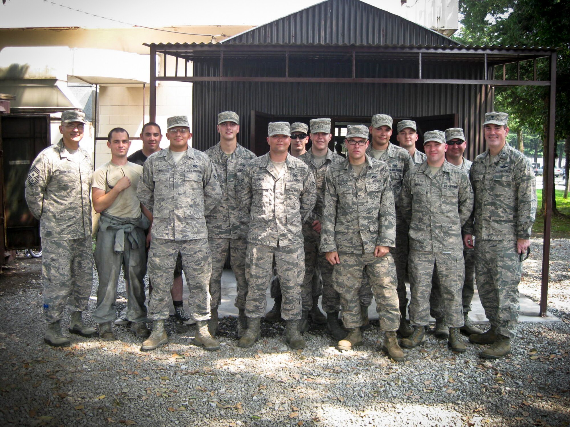 YOKOTA AIR BASE, Japan -- Volunteers from the 374th Civil Engineer Squadron and 374th Medical Group here on Yokota Air Base, Japan, stand with Col. Mark August, 374th Airlift Wing commander and Command Chief Master Sgt. Manuel Roblesreynoso, wing command chief, upon completion of the addition of a new building at the  Airman’s Attic Aug. 14, 2013. The new and improved structure will provide a dry working area for the volunteers, as well as prevent water damage to the donated items. The new area will also help secure the items once they are organized. (U.S. Air Force photo by Staff Sgt Stacy Moless)