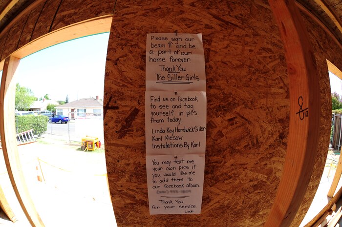A note written by Linda Siller, hangs from the wall of her future home under construction in Marysville, Calif. Beale Airmen have volunteered their time to aid in the construction and many have signed a large wooden beam within the home. (U.S. Air Force photo by Airman 1st Class Bobby Cummings/Released)