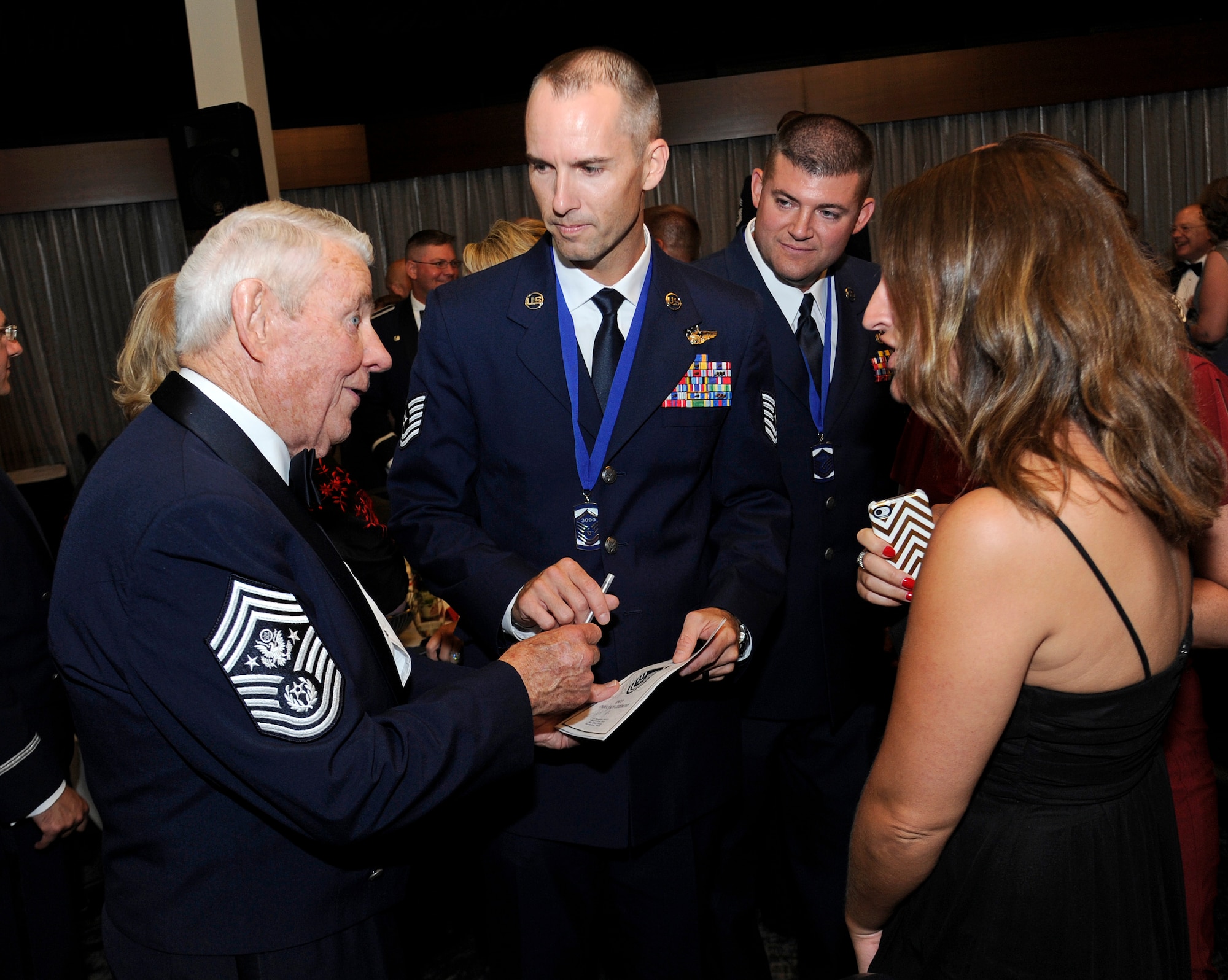Retired Chief Master Sgt. Robert Gaylor, Fifth Chief Master Sergeant of the Air Force, speaks with Tech. Sgt. Robert Stinnett, 92nd Air Refueling Squadron boom operator, during the Senior NCO Induction ceremony in Spokane, Wash., Aug. 16, 2013. Gaylor spoke about his time in the Air Force and emphasized the importance of the senior NCO’s. (U.S. Air Force photo by Airman 1st Class Ryan Zeski/Released)
