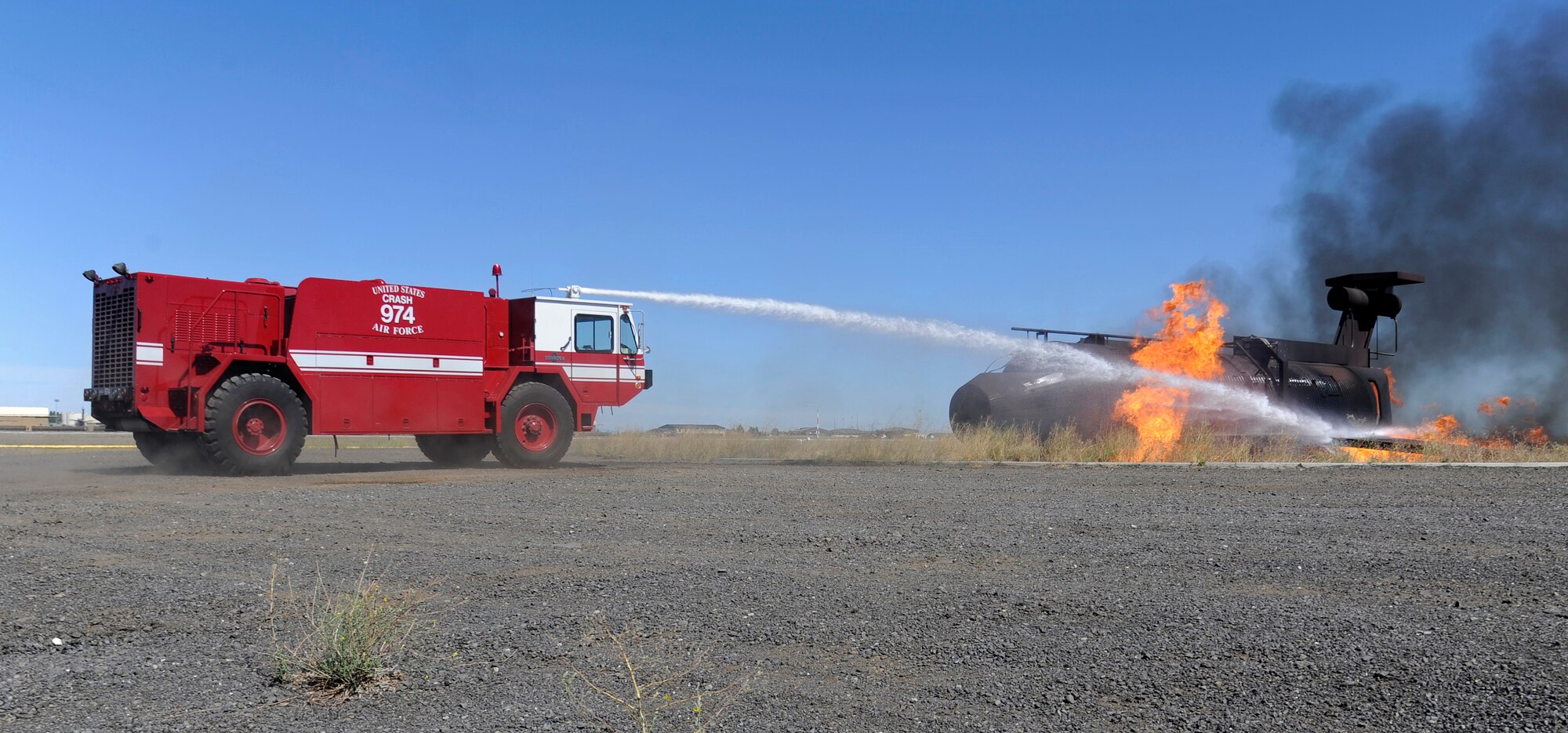 A controlled burn is put out as part of the firefighter demonstration during the Family Recognition Day event at Fairchild Air Force Base, Wash., Aug. 19, 2013. The purpose of the event was to allow families to see what Team Fairchild does on a daily basis. (U.S. Air Force photo by Airman 1st Class Ryan Zeski/Released)