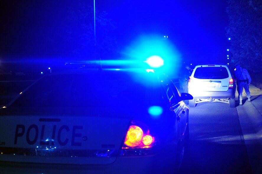 Officer John Gorrell and Staff Sgt. Craig Sams, both 92nd Security Forces Squadron installation patrolmen, conduct a traffic stop at Fairchild Air Force Base, Wash., Aug. 8, 2013. The mission for the 92nd SFS is to provide worldwide expeditionary combat support and force protection for the 92nd Air Refueling Wing, 141st Air Refueling Wing, Air Force Survival School and 15 joint tenant units. (U.S. Air Force photo by Senior Airman Taylor Curry/Released)
