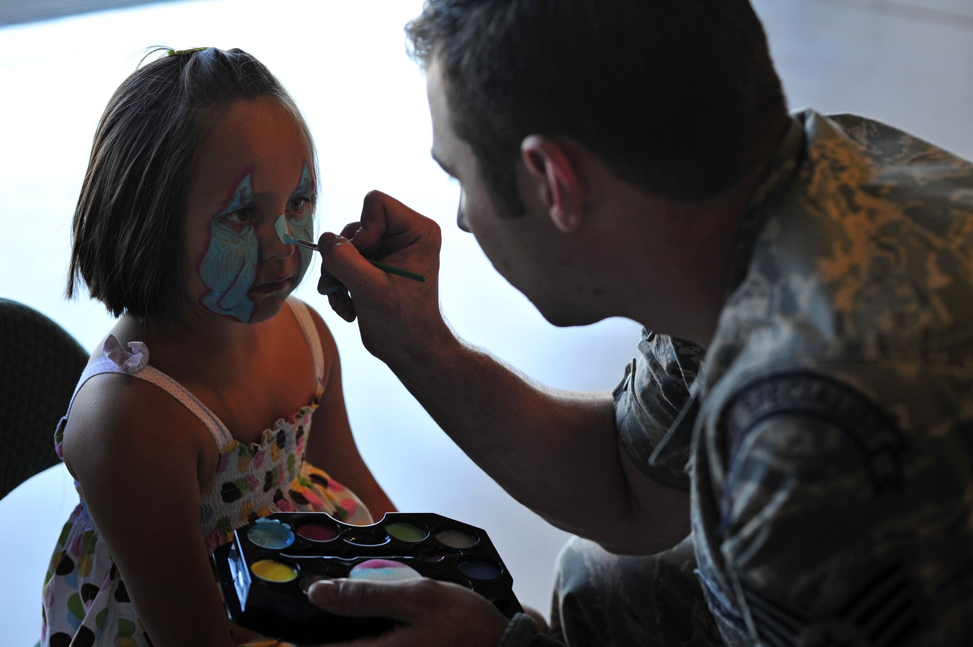 Children receive face paintings during the Family Recognition Day event at Fairchild Air Force Base, Wash., Aug. 19, 2013. The purpose of the event was to allow families an opportunity to see what Team Fairchild’s Airmen do on a daily basis. (U.S. Air Force photo by Senior Airman Taylor Curry/Released)