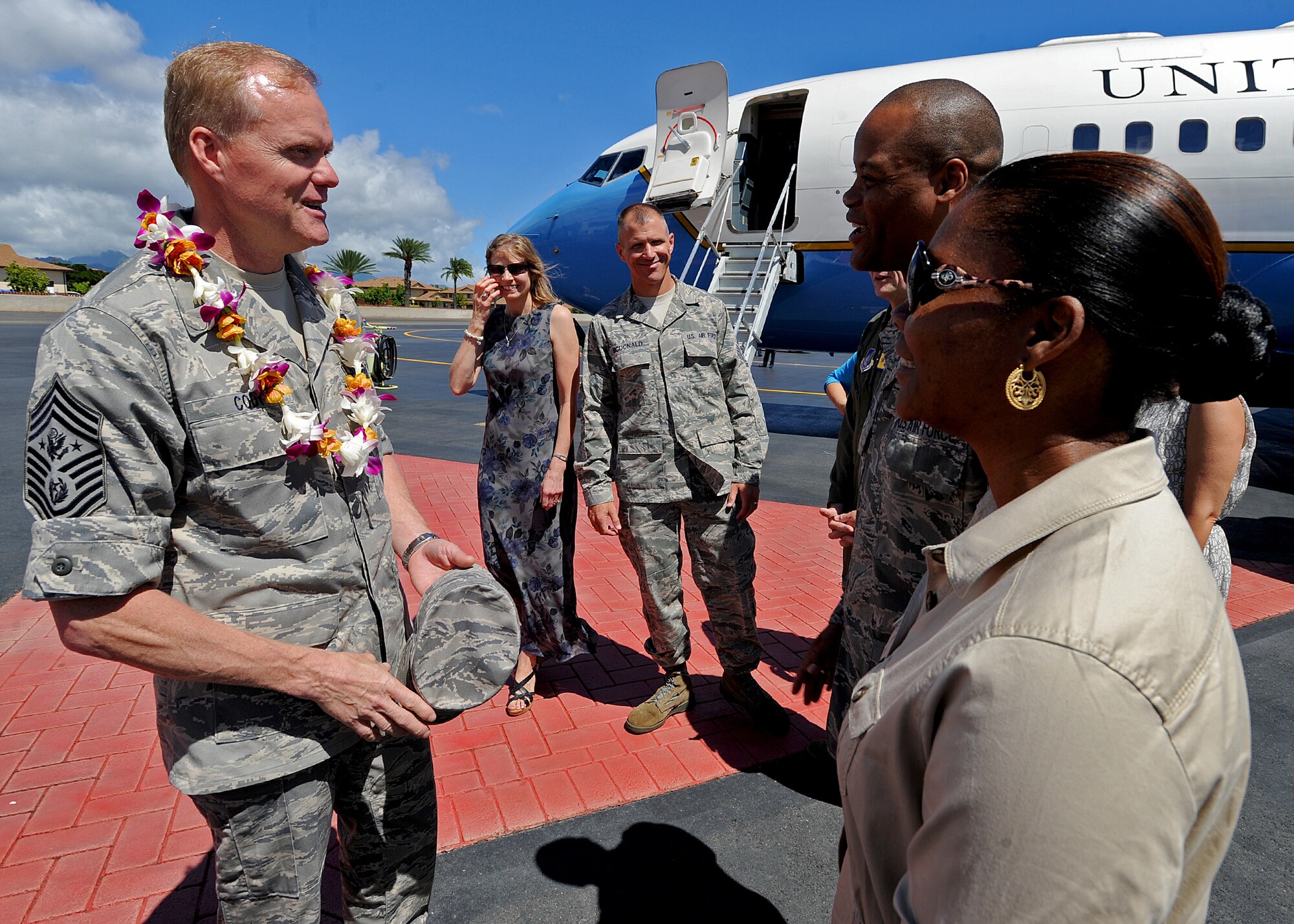 Chief Master Sgt. Leslie Bramlett, 15th Wing command chief, right, and his wife Tracy Bramlett, welcome Chief Master Sgt. of the Air Force James Cody, left, to Joint Base Pearl Harbor-Hickam, Hawaii, Aug. 18, 2013. During this trip, Air Force Chief of Staff Gen. Mark A. Welsh III and Cody will meet with Airmen across the region, and take a close look at how to best prepare and care for America's Airmen and their families across the Pacific. (U.S. Air Force photo/Tech. Sgt. Jerome S. Tayborn)