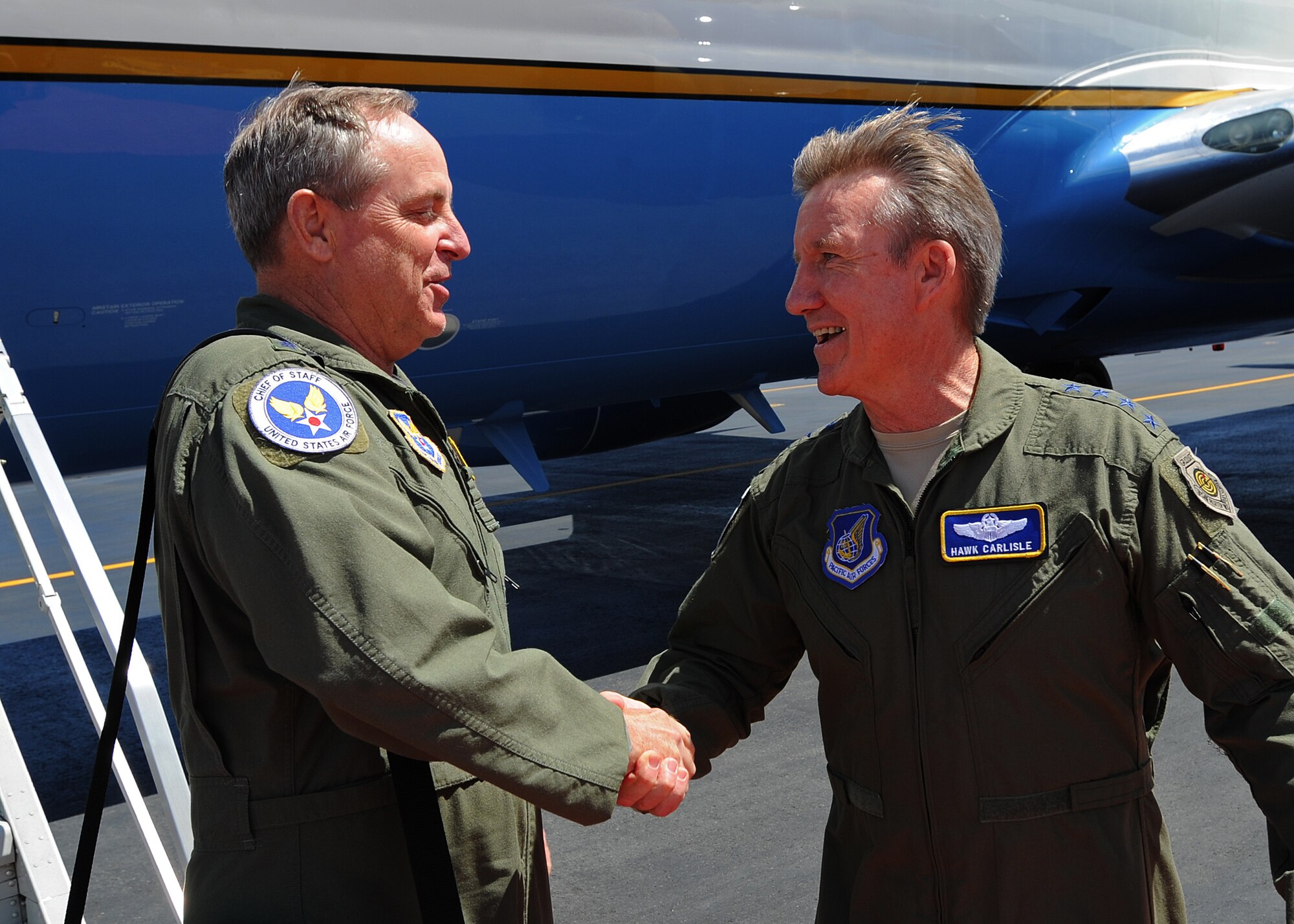 Gen. Hawk Carlisle, U.S. Pacific Air Forces commander, right, welcomes Air Force Chief of Staff Gen. Mark A. Welsh III, left, shortly after his arrival at Joint Base Pearl Harbor-Hickam, Hawaii, Aug. 18, 2013. This trip is Welsh's first visit to the region as Air Force chief of staff and provides him, along with Chief Master Sergeant of the Air Force James Cody, an opportunity to meet Airmen and their families across the Pacific.
 (U.S. Air Force photo/Tech. Sgt. Jerome S. Tayborn)
