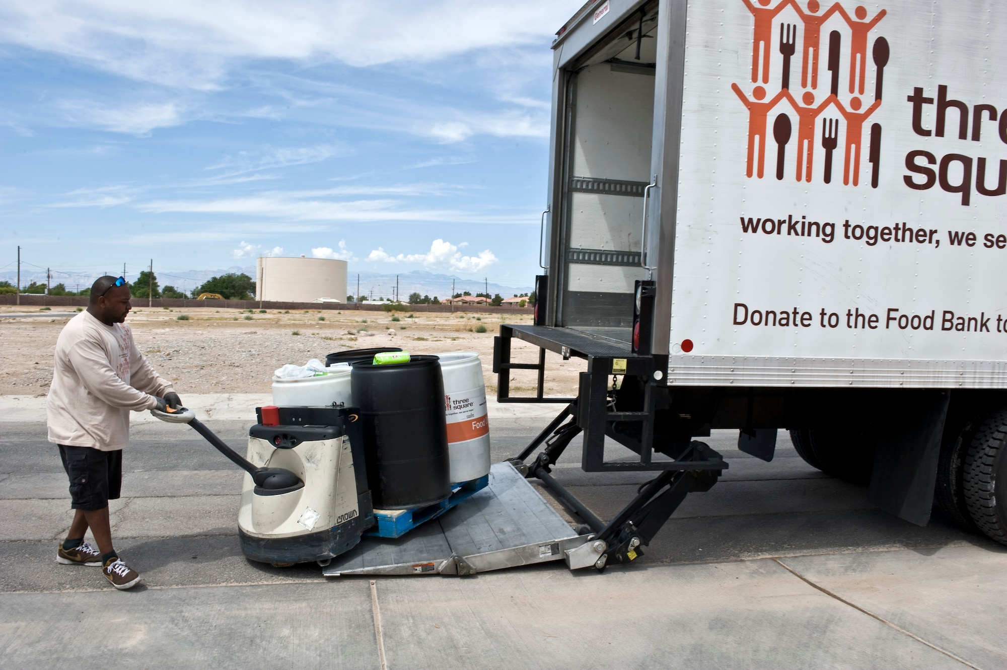 Derrell Robertson, Three Square delivery truck driver, loads food, being donated to Feds Feed Families food drive campaign, onto his truck at the Warrior Fitness Center Aug. 19, 2013, at Nellis Air Force Base, Nev. In 2012, the food donation from the federal government was 7.3 million pounds of food items. The department of defense alone contributed over 2.1 million pounds of food. (U.S. Air Force photo by Senior Airman Matthew Lancaster)