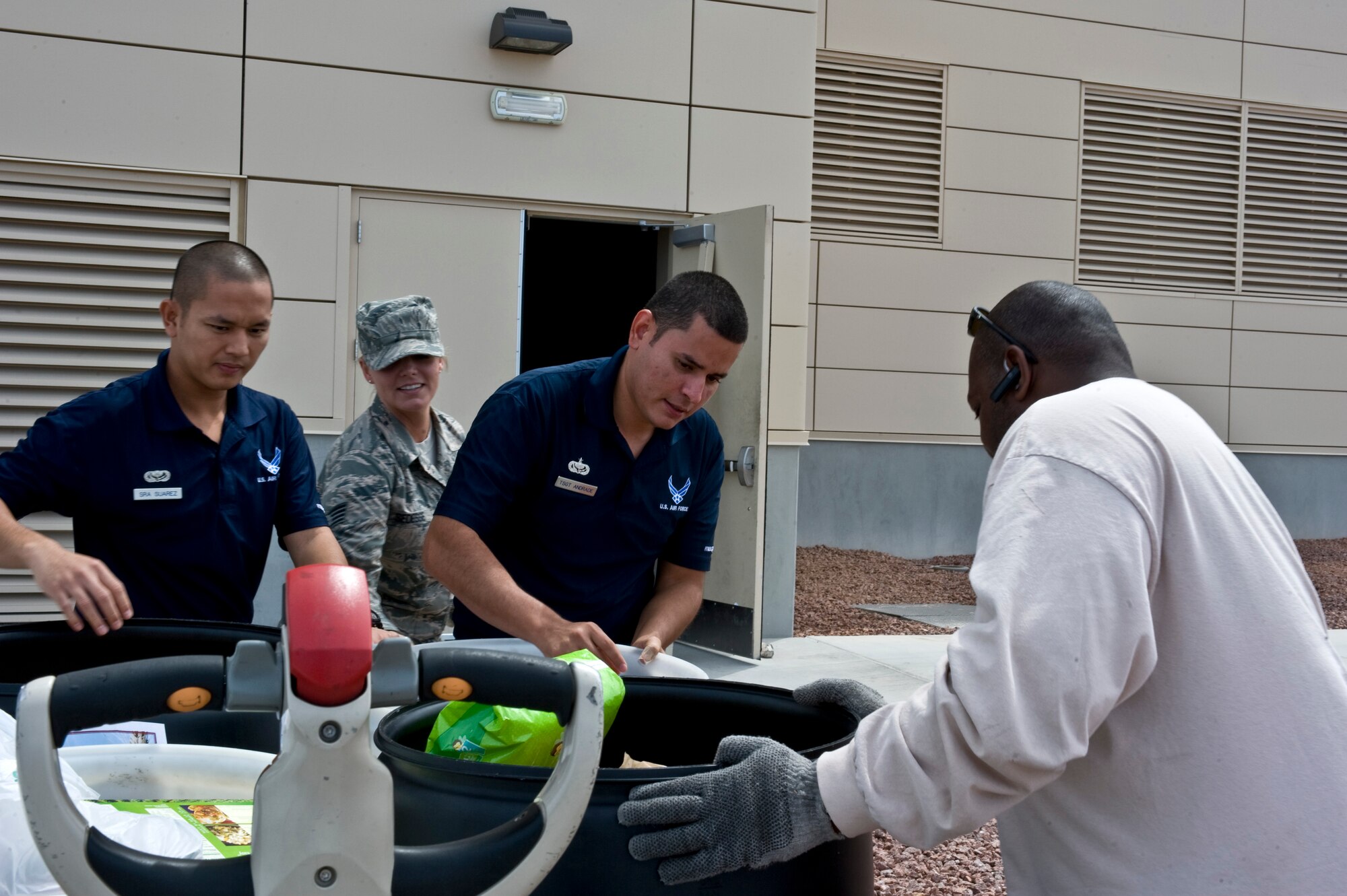 Senior Airman Alvin Suavez, 99th Force Support Squadron equipment and special event manager, Staff Sgt. Nichole Sedesse, United States Air Force Warfare Center ceremonies NCO, Tech. Sgt. Noe Adrade, 99 FSS fitness program manager, and Derrell Robertson, Three Square delivery truck driver, place food barrels being donated to Feds Feed Families food drive campaign onto a pallet at the Warrior Fitness Center Aug. 19, 2013, at Nellis Air Force Base, Nev. The Feds Feed Families campaign is a voluntary effort undertaken by federal employees to bring non-perishable food items to their offices for distribution to local food banks. (U.S. Air Force photo by Senior Airman Matthew Lancaster)