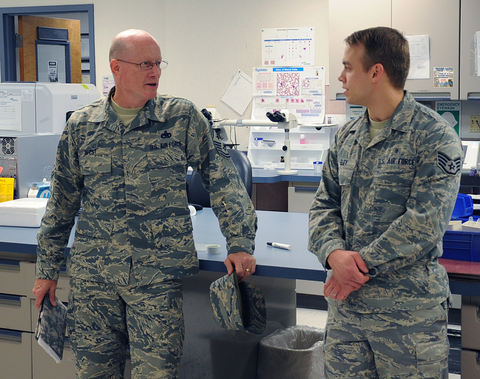 Chief Master Sgt. Terry West, 8th Air Force command chief, speaks with Staff Sgt. David Eley, 2nd Medical Support Squadron laboratory technician, during his visit to the 2nd Medical Group on Barksdale Air Force Base, La., Aug. 20, 2013. The mission of the 2nd MDSS laboratory is to provide laboratory support to the medical staff of the 2nd Medical Group through accurate and timely results obtained by the scientific application of accepted analytical principles. (U.S. Air Force photo/Senior Airman Sean Martin)
